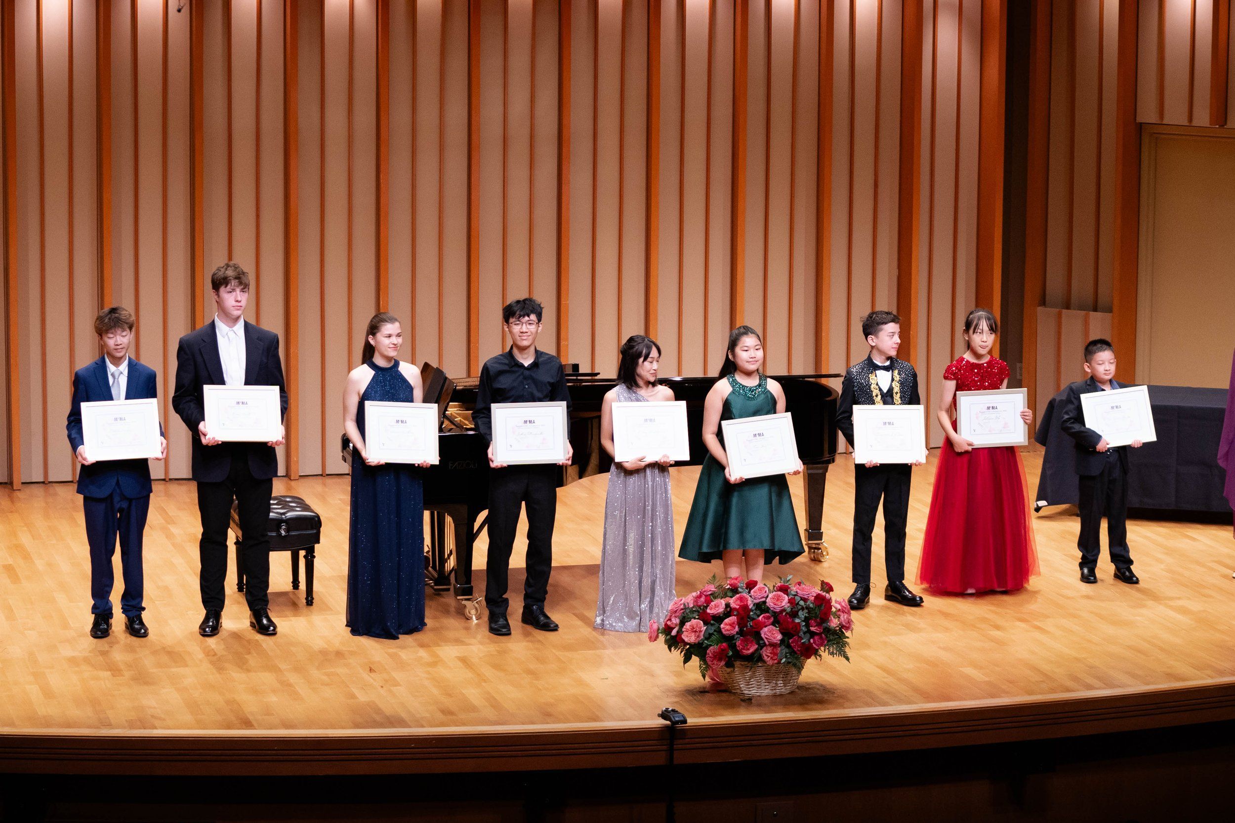 Young musicians and jury members on stage at Zipper Concert Hall for the MIMA Young Artist Competition.